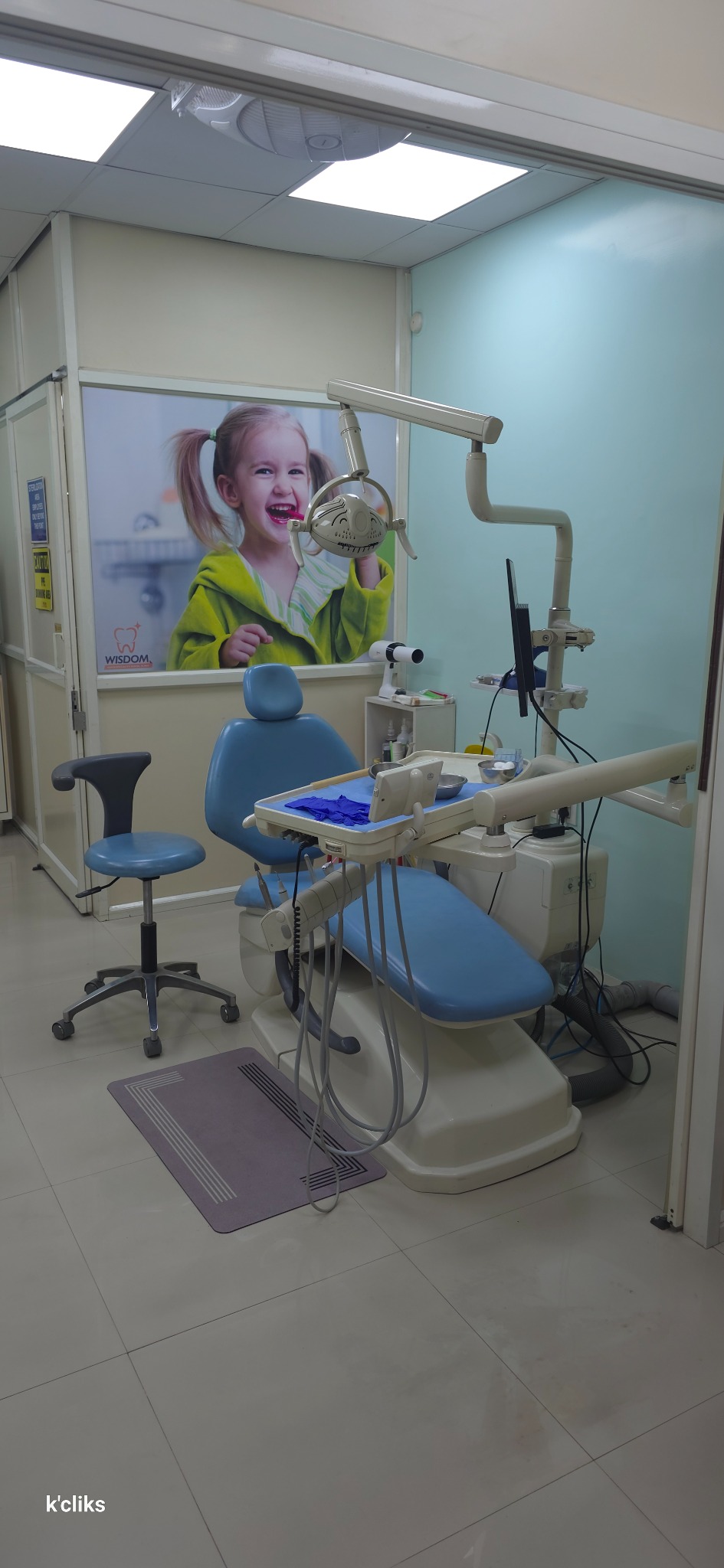 Full view of a dental chair and examination light