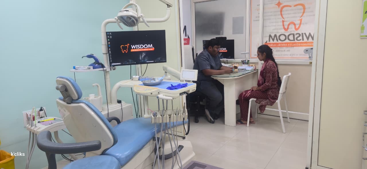 Wisdom Superspeciality Dental Clinic treatment room in Hyderabad with a dentist consulting a patient